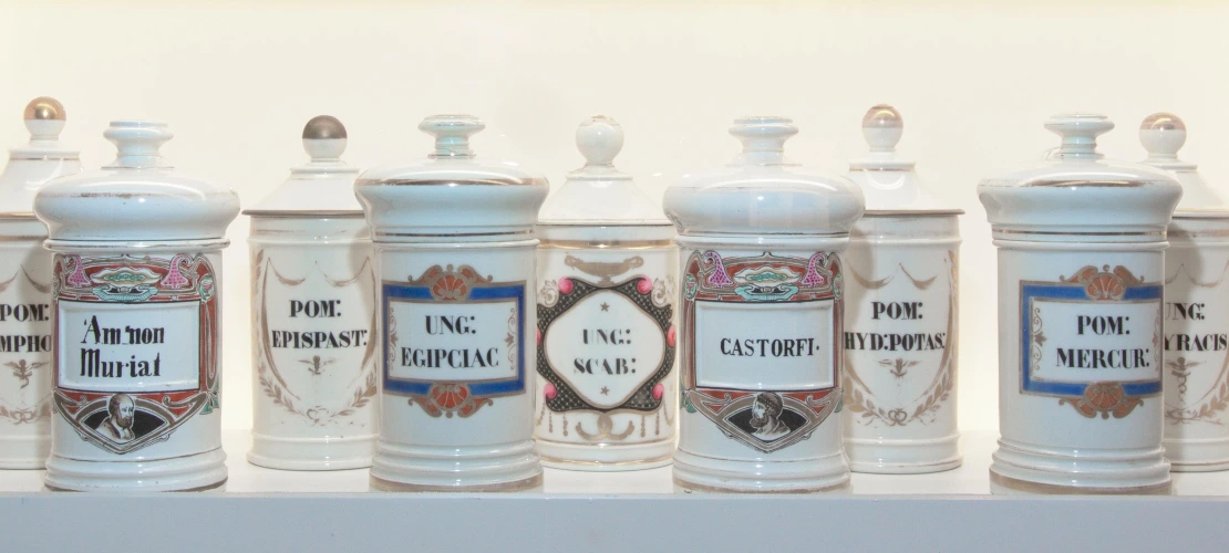Row of blue and white ceramic apothecary jars.