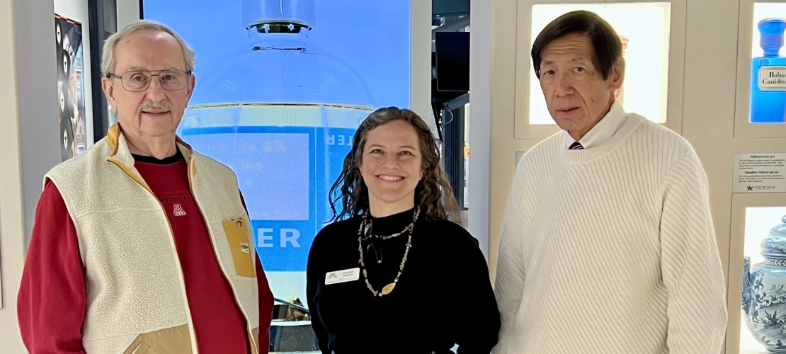 Advisory Board members and guides, Larry Cohen and Dr. Ted Tong stand in the museum with Directo Heather Ingram