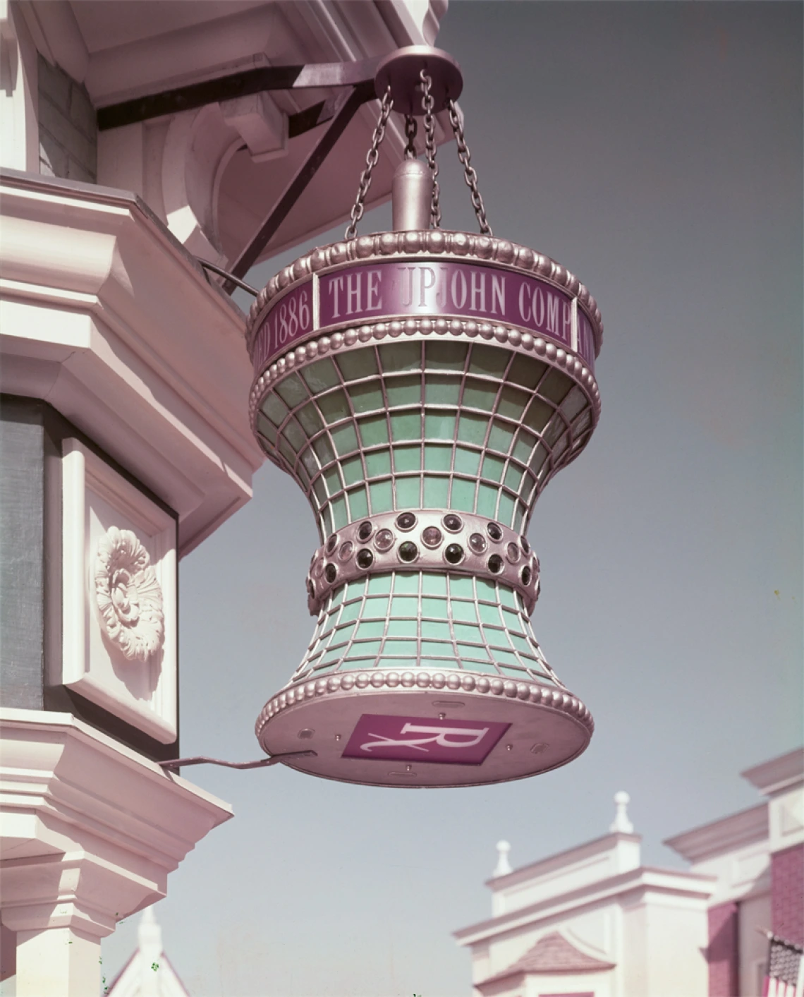 A mortar-and-pestle-shaped lamp hangs on the corner of the Upjohn Pharmacy