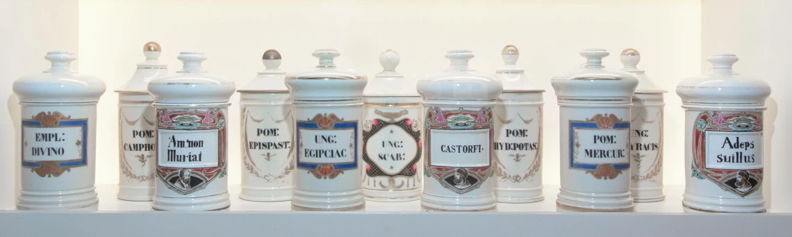 Row of blue and white ceramic apothecary jars.
