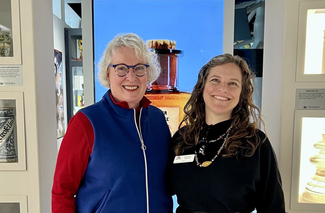 Greeter and Guide Martie Fankhauser stands with Director Heather Ingram in the museum