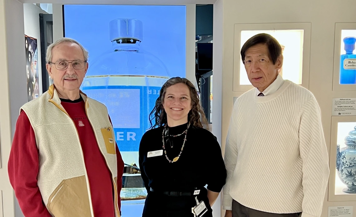 Advisory Board members and guides, Larry Cohen and Dr. Ted Tong stand in the museum with Directo Heather Ingram