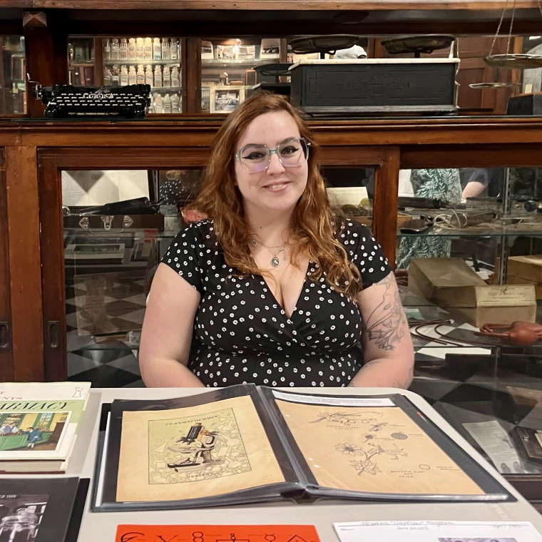 Jessie smiles while seated in front of a photo album